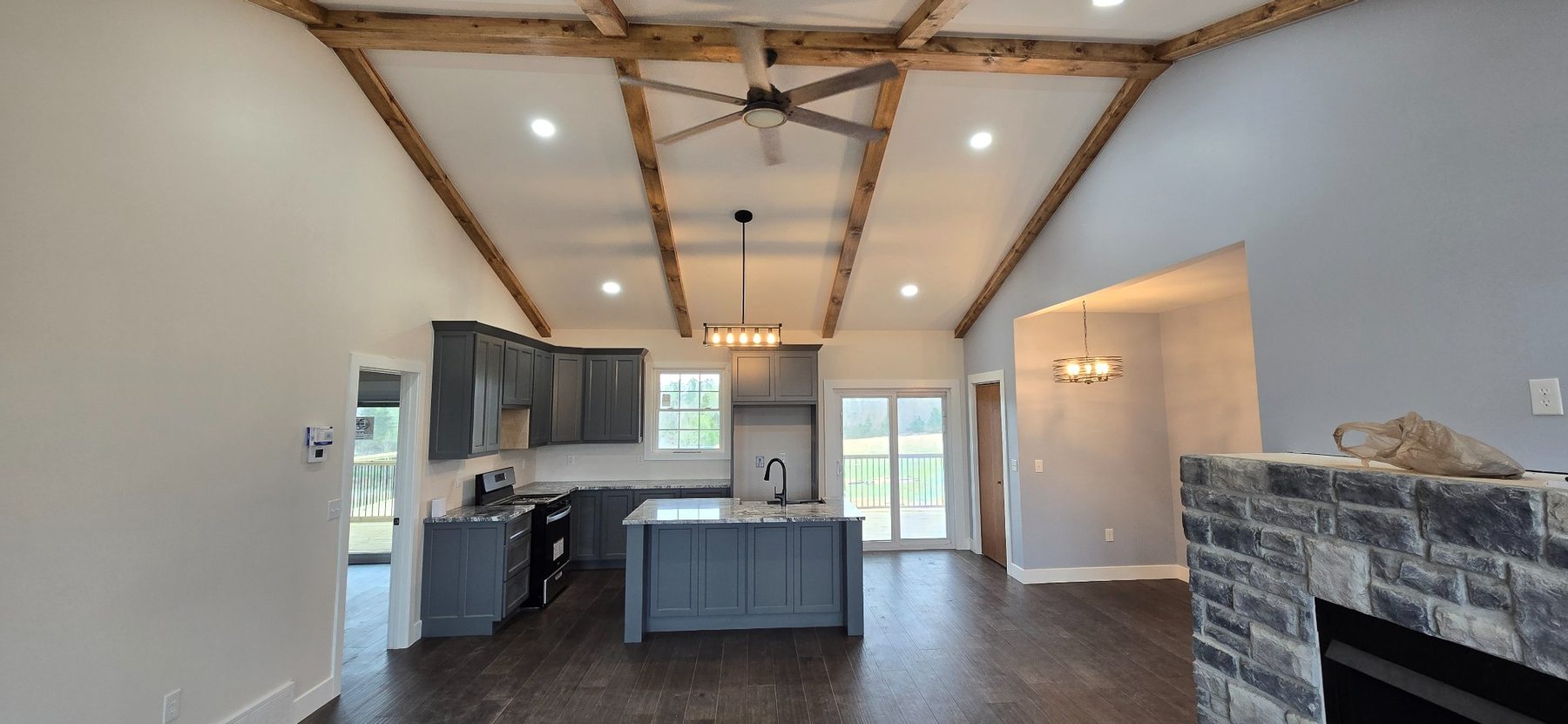 Open kitchen and living area with exposed beams
