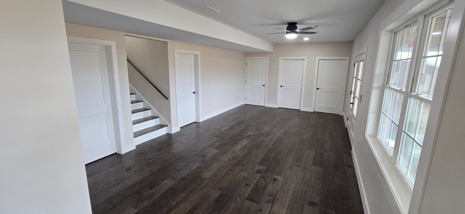 Living area with windows and staircase