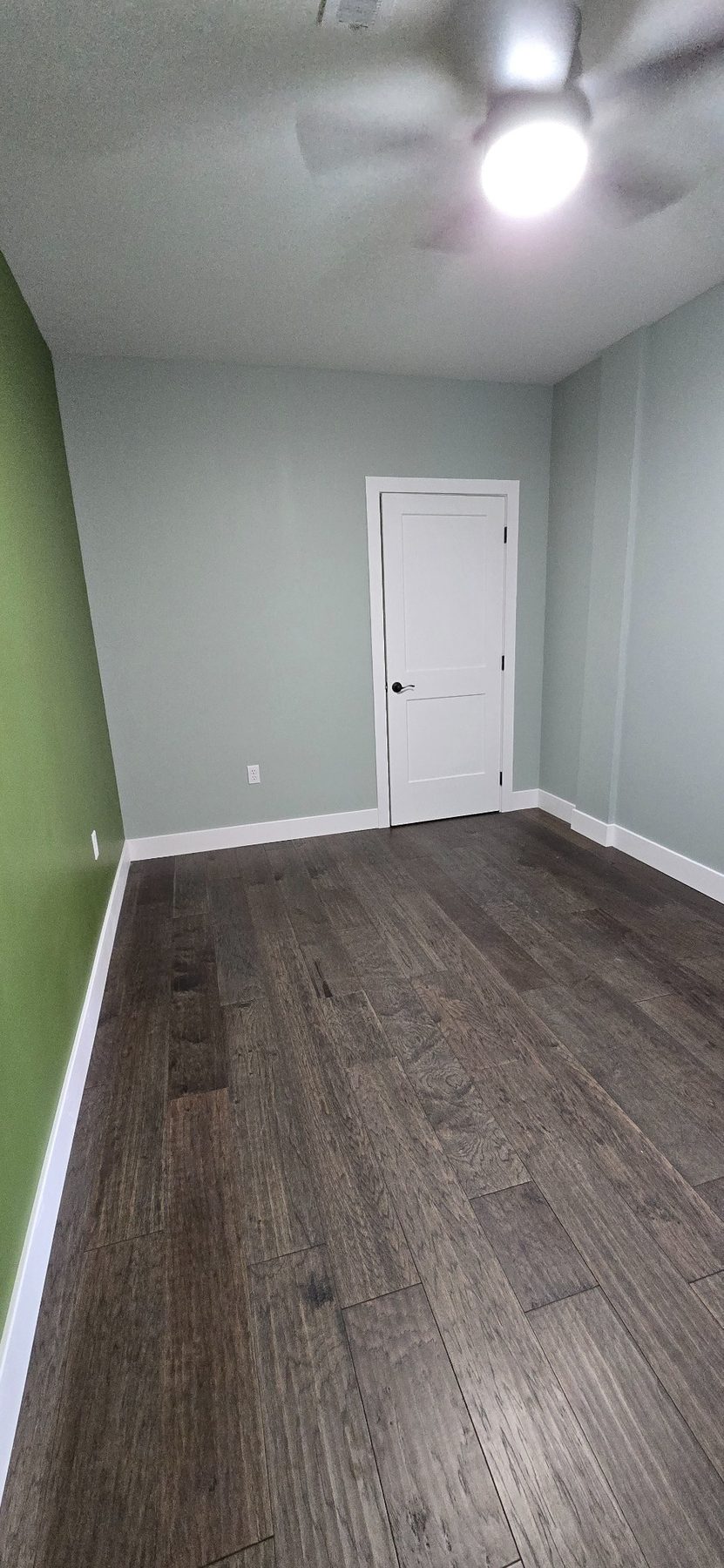 Room with ceiling fan and wood-look floor