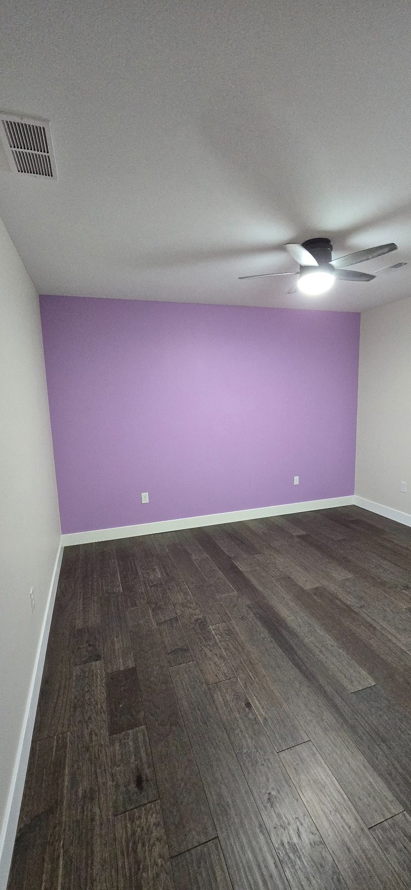 Bedroom with purple accent wall