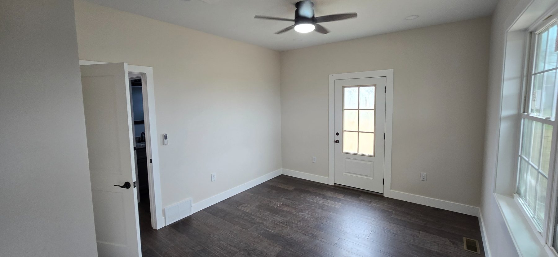 Living area with windows and entry door