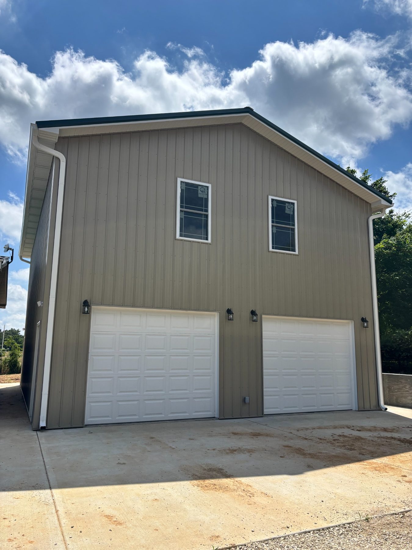 Front of the two-story garage with two garage doors
