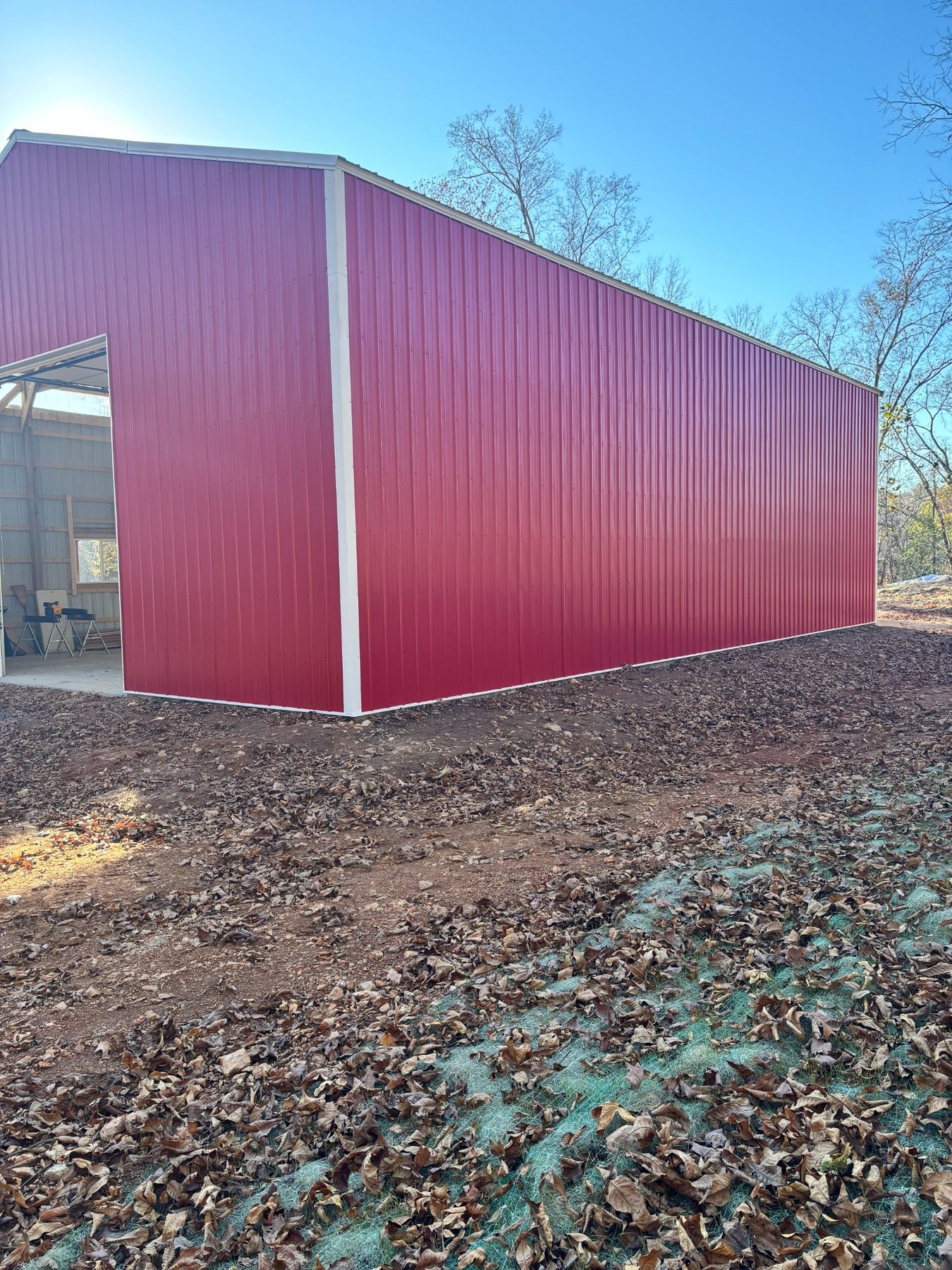 Long side of the red metal building