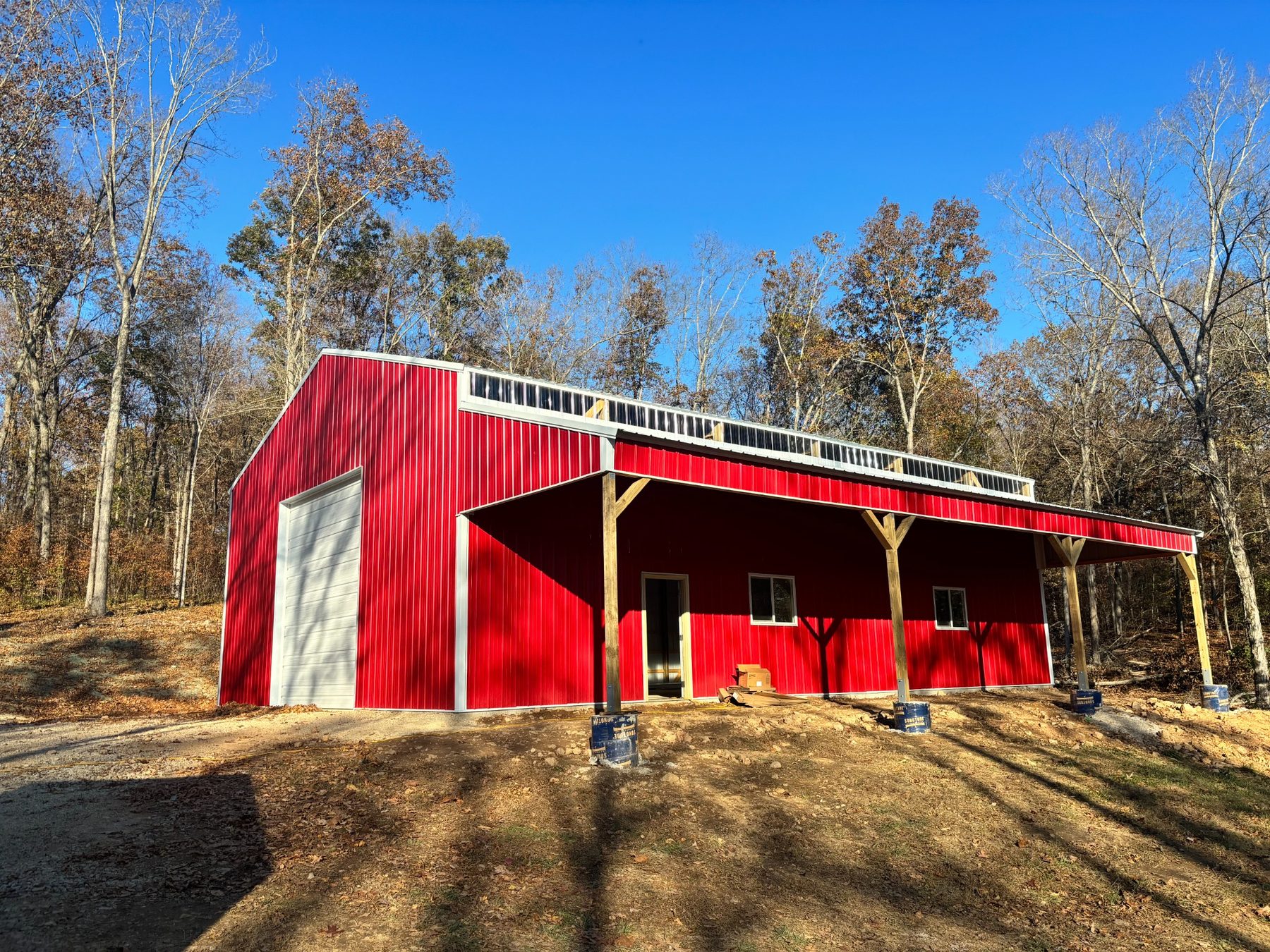 Front and covered side of the red metal building